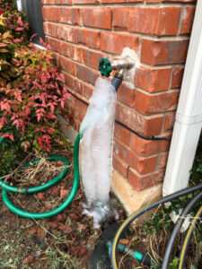 Frozen outdoor pipe in winter