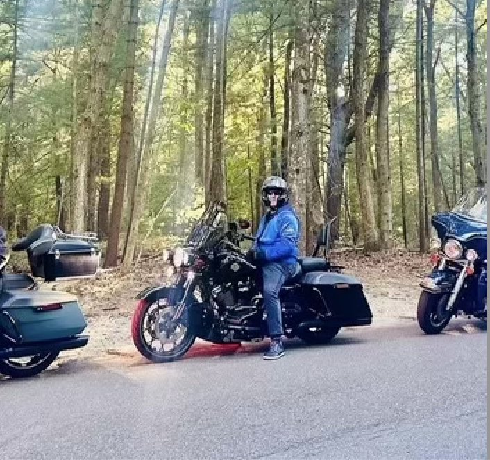 Man enjoying a Long Island motorcycle ride on scenic road.